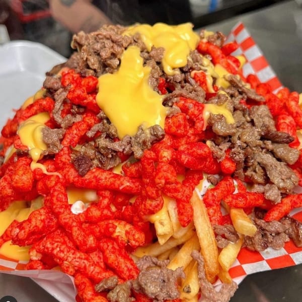 Sayulitas' Mexican fries loaded with carne asada, Cheetos, and nacho cheese sauce.
