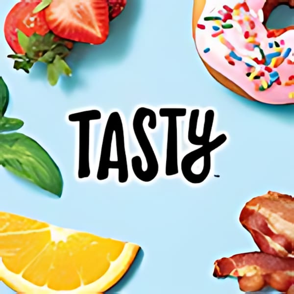 The word "TASTY" centered, surrounded by strawberries, a donut, an orange slice, and bacon.